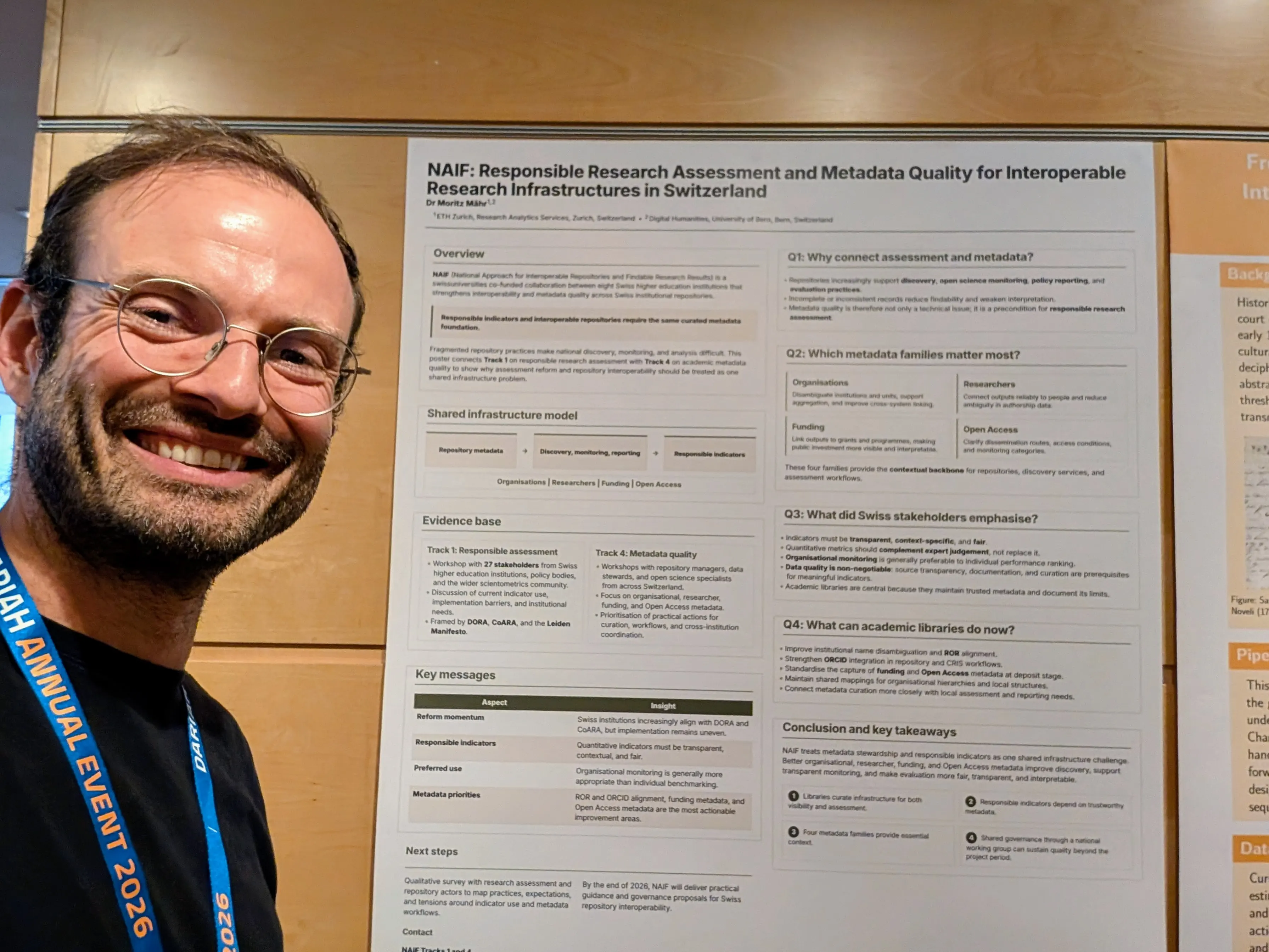 Dr Moritz Mähr standing next to the NAIF poster at the DARIAH Annual Event 2026 in Rome